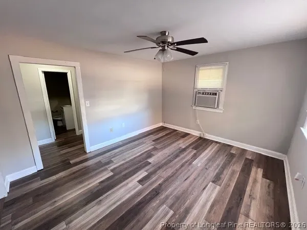 a view of an empty room and wooden floor