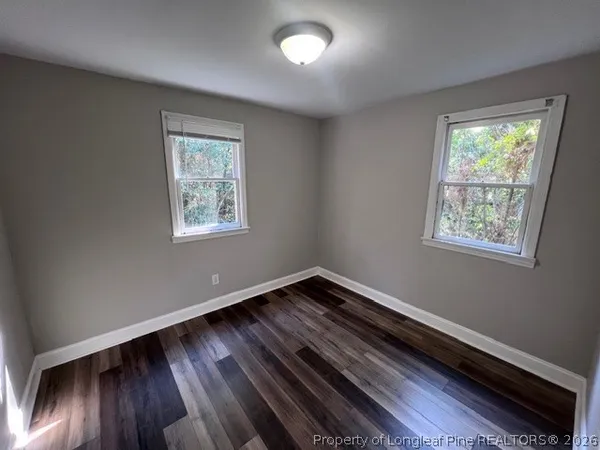 a view of an empty room and wooden floor