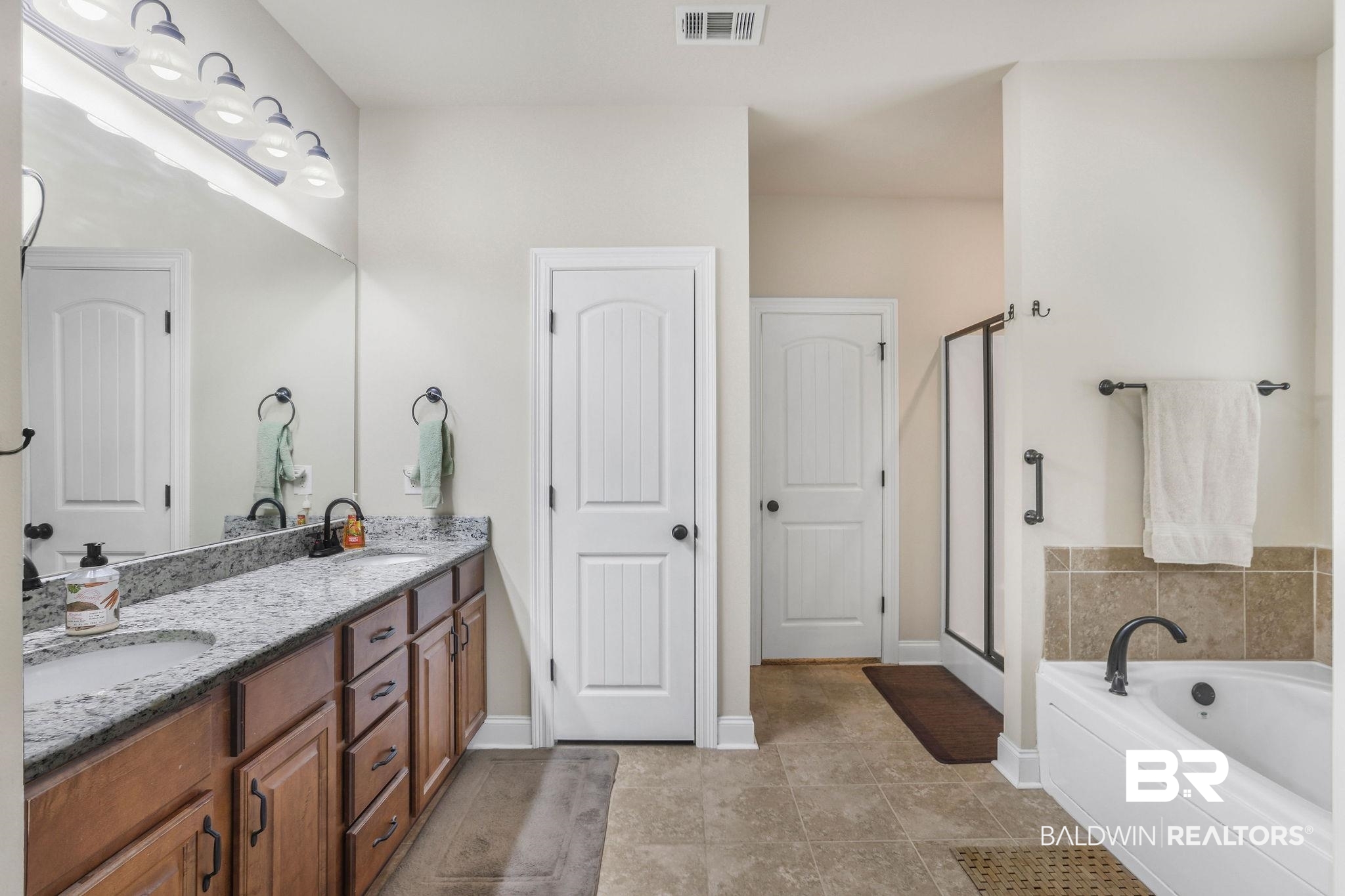 1086 Destin Avenue Foley, AL 36535 - Photo 11 of 30 Bathroom with vanity, tile patterned floors, and separate shower and tub