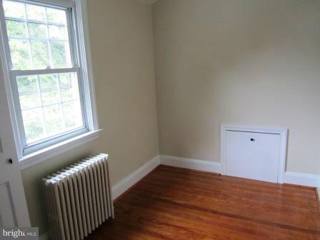 3009 Dunran Road Dundalk, MD 21222 - Photo 4 of 26 a view of an empty room with wooden floor and a window