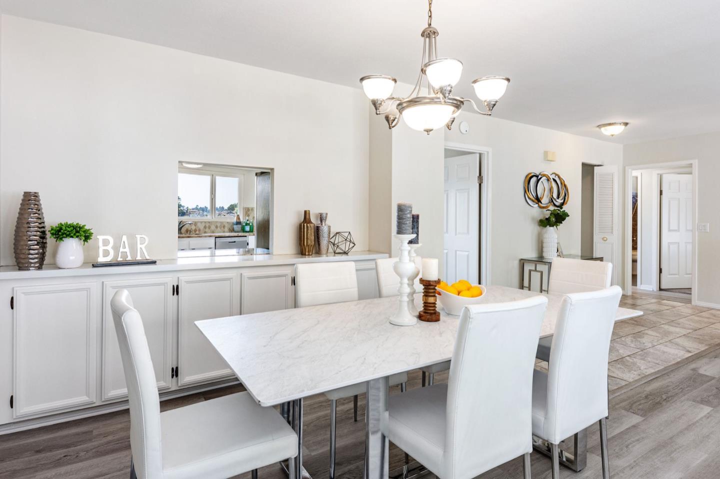 1063 Glacier Avenue Pacifica, CA 94044 - Photo 19 of 63 a view of a dining room with furniture and wooden floor