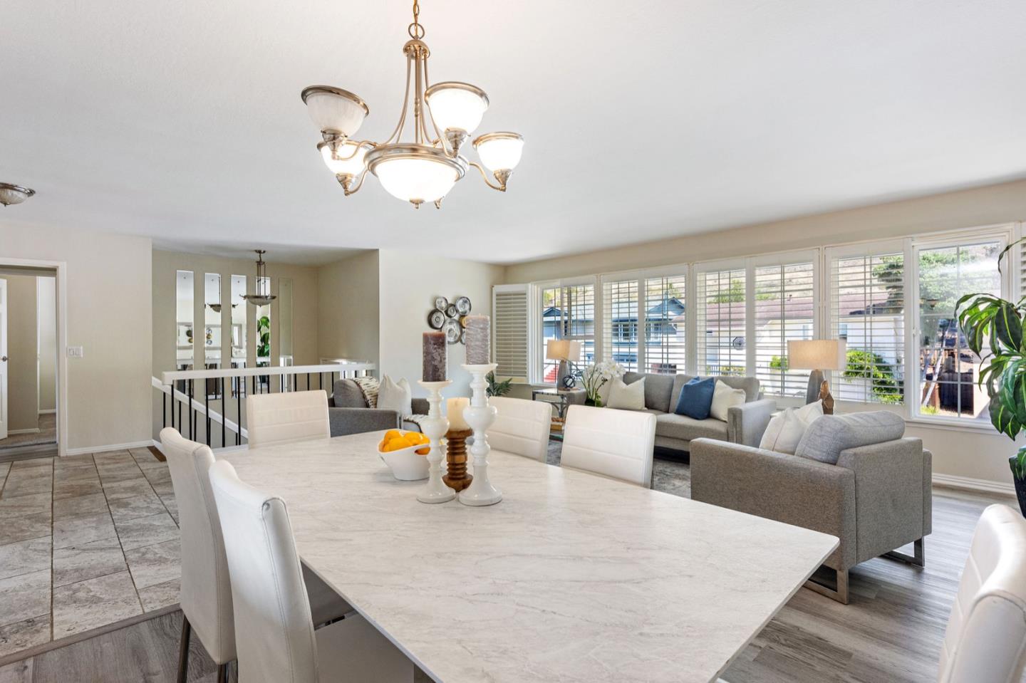 1063 Glacier Avenue Pacifica, CA 94044 - Photo 21 of 63 a view of a dining room with furniture wooden floor and chandelier