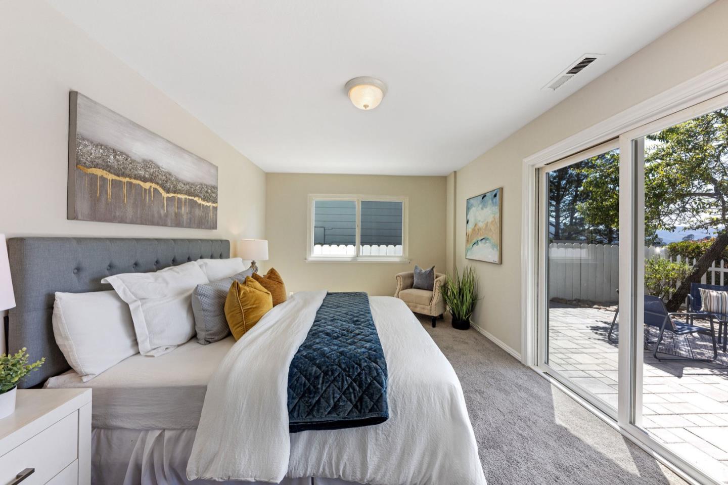 1063 Glacier Avenue Pacifica, CA 94044 - Photo 29 of 63 a bedroom with a bed and wooden floor