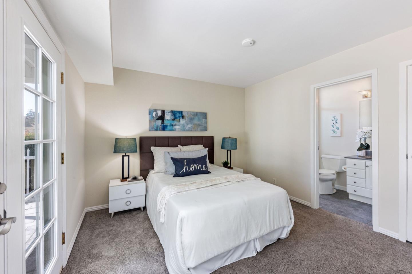 1063 Glacier Avenue Pacifica, CA 94044 - Photo 32 of 63 a bedroom with a bed and a view of bathroom