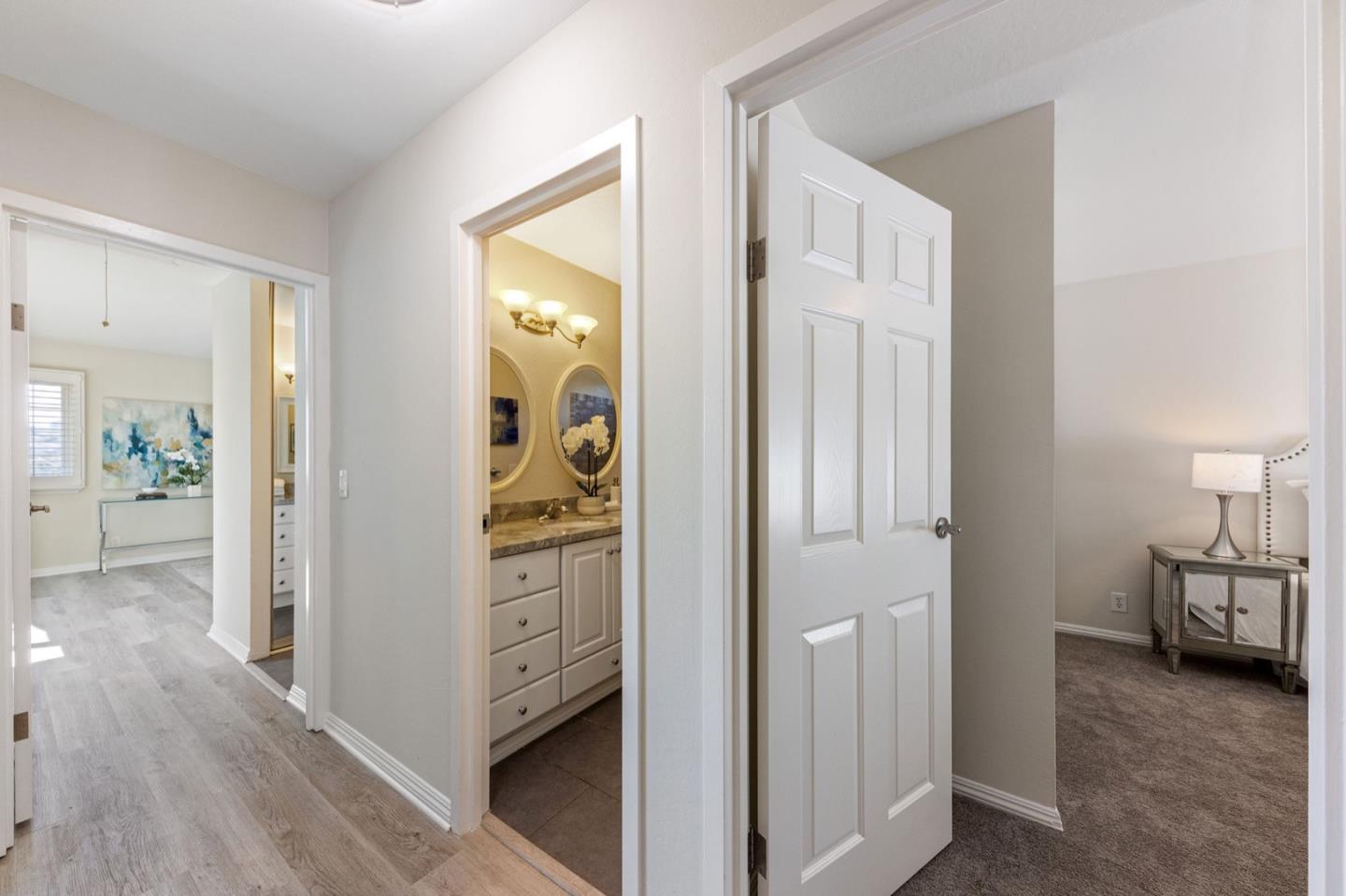 1063 Glacier Avenue Pacifica, CA 94044 - Photo 44 of 63 a view of a hallway with bathroom and wooden floor