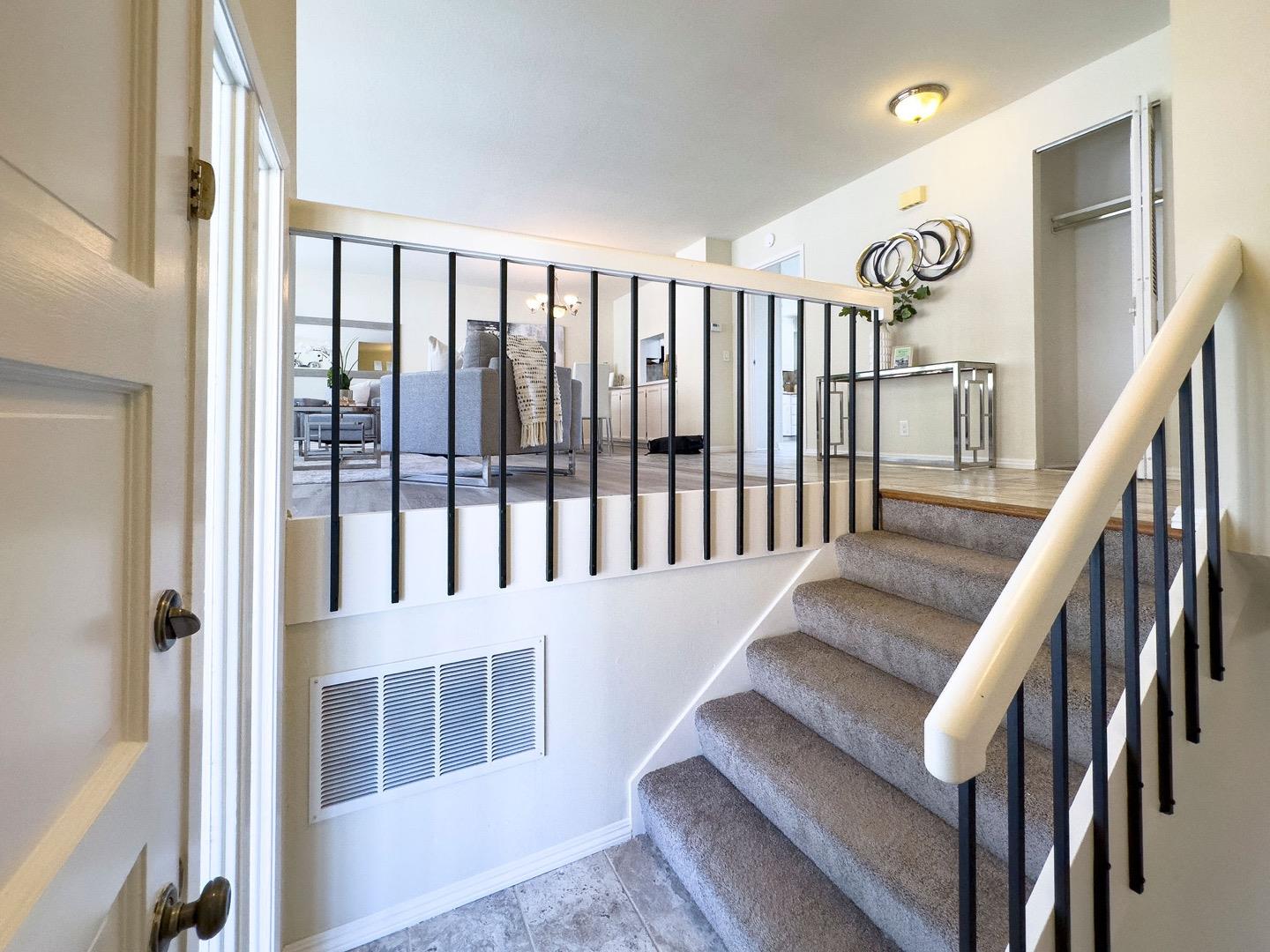 1063 Glacier Avenue Pacifica, CA 94044 - Photo 8 of 63 a view of staircase with lots of frames on wall and a window