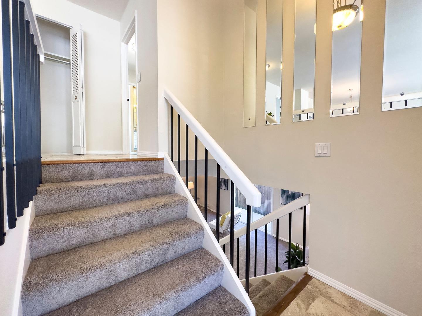 1063 Glacier Avenue Pacifica, CA 94044 - Photo 9 of 63 a view of staircase with lots of frames on wall and a large window