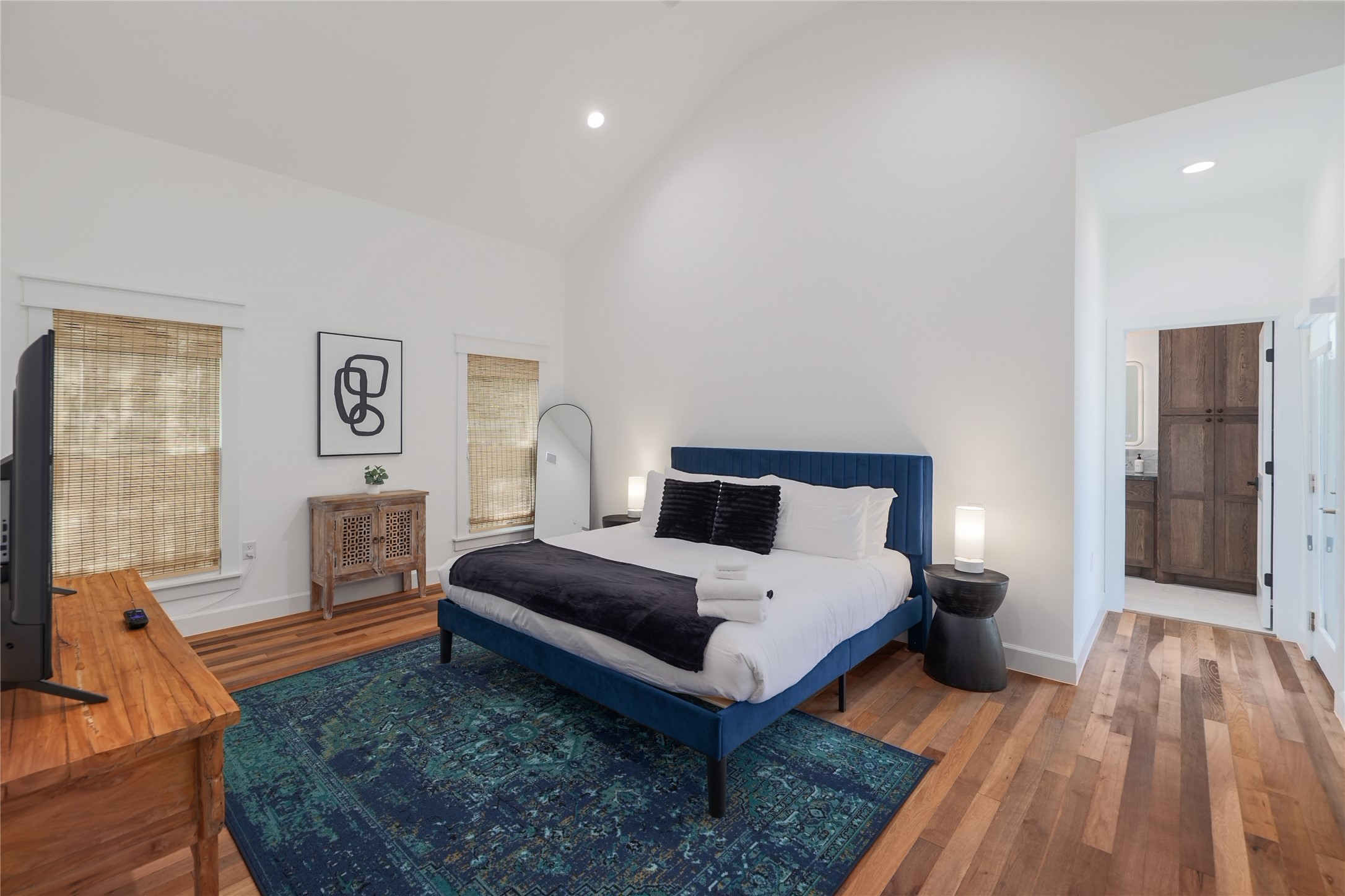 1701 Willow Street Austin, TX 78702 - Photo 20 of 29 a spacious bedroom with a bed and wooden floor