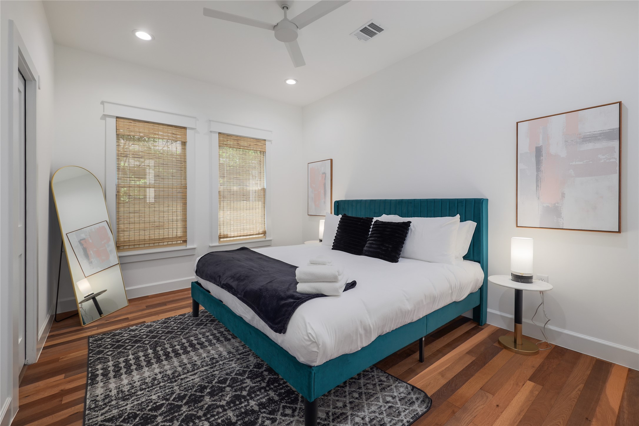 1701 Willow Street Austin, TX 78702 - Photo 24 of 29 a bedroom with a bed lamp and a large window