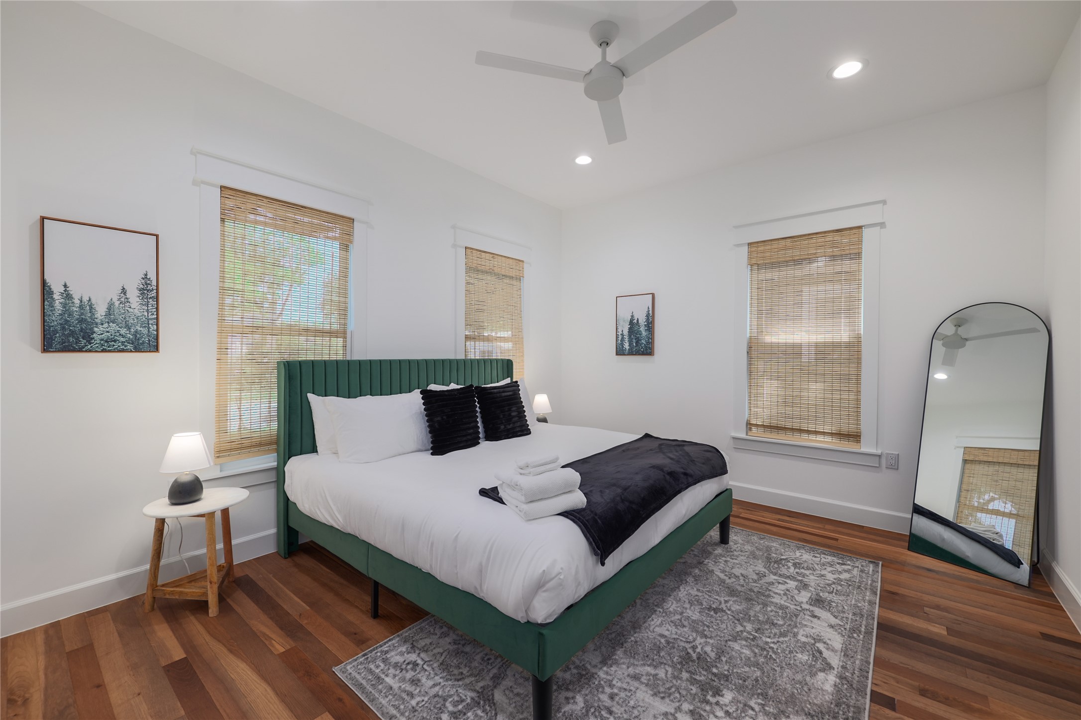 1701 Willow Street Austin, TX 78702 - Photo 26 of 29 a bedroom with a bed wooden floor and a lamp