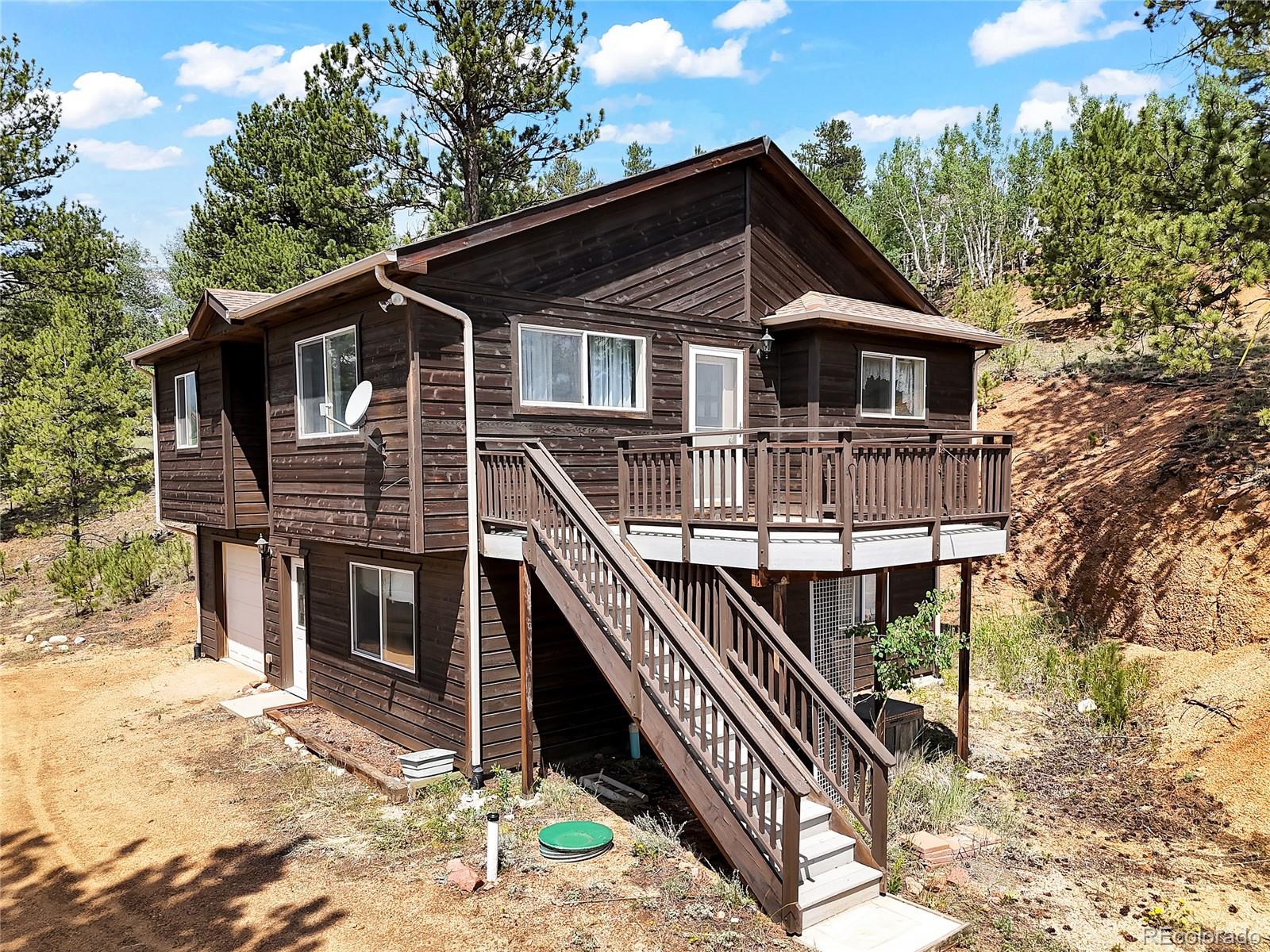367 Moore Street Bailey, CO 80421 - Photo 1 of 32 a front view of a house with iron stairs