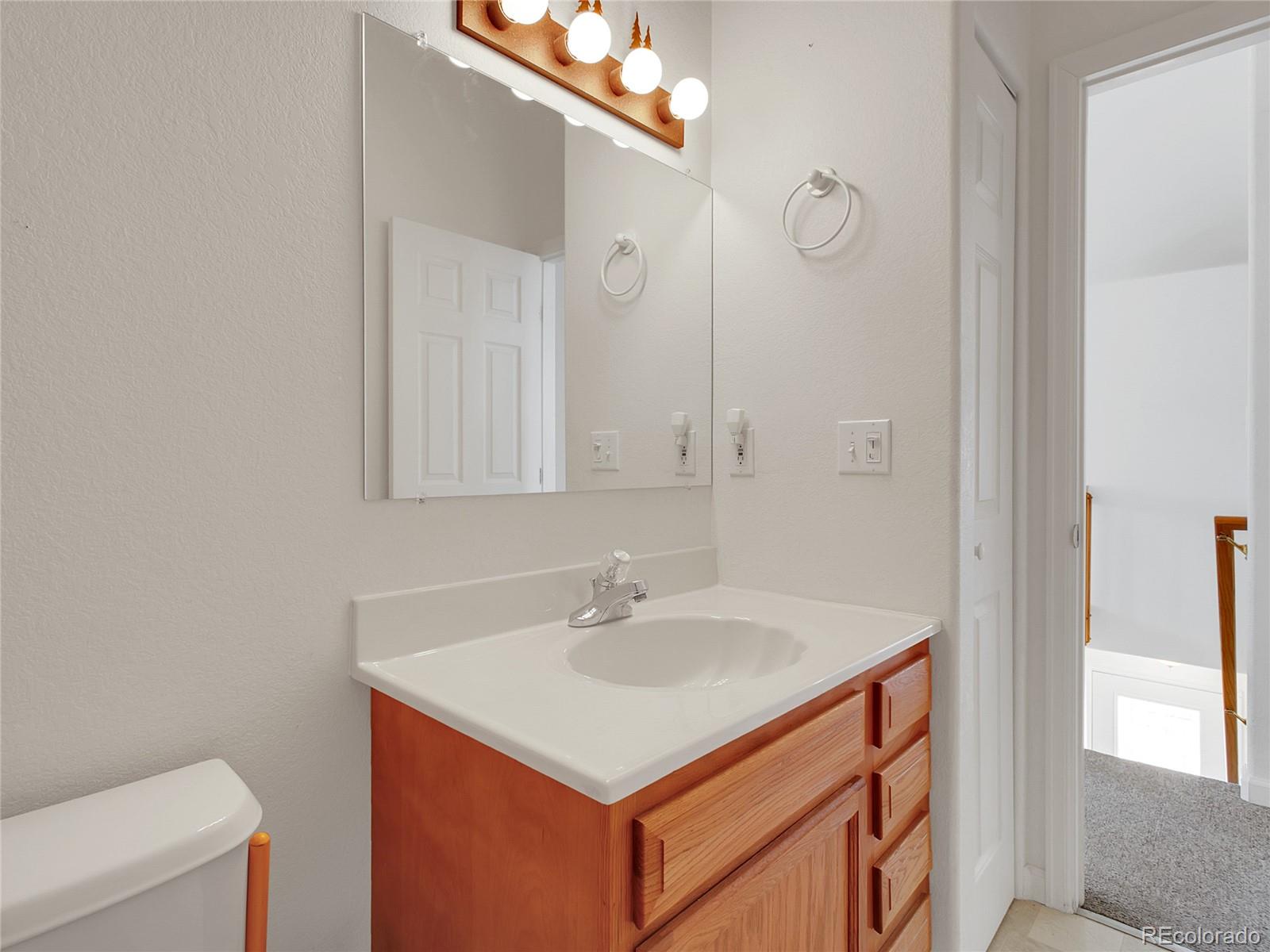 367 Moore Street Bailey, CO 80421 - Photo 15 of 32 a bathroom with a sink vanity and a mirror