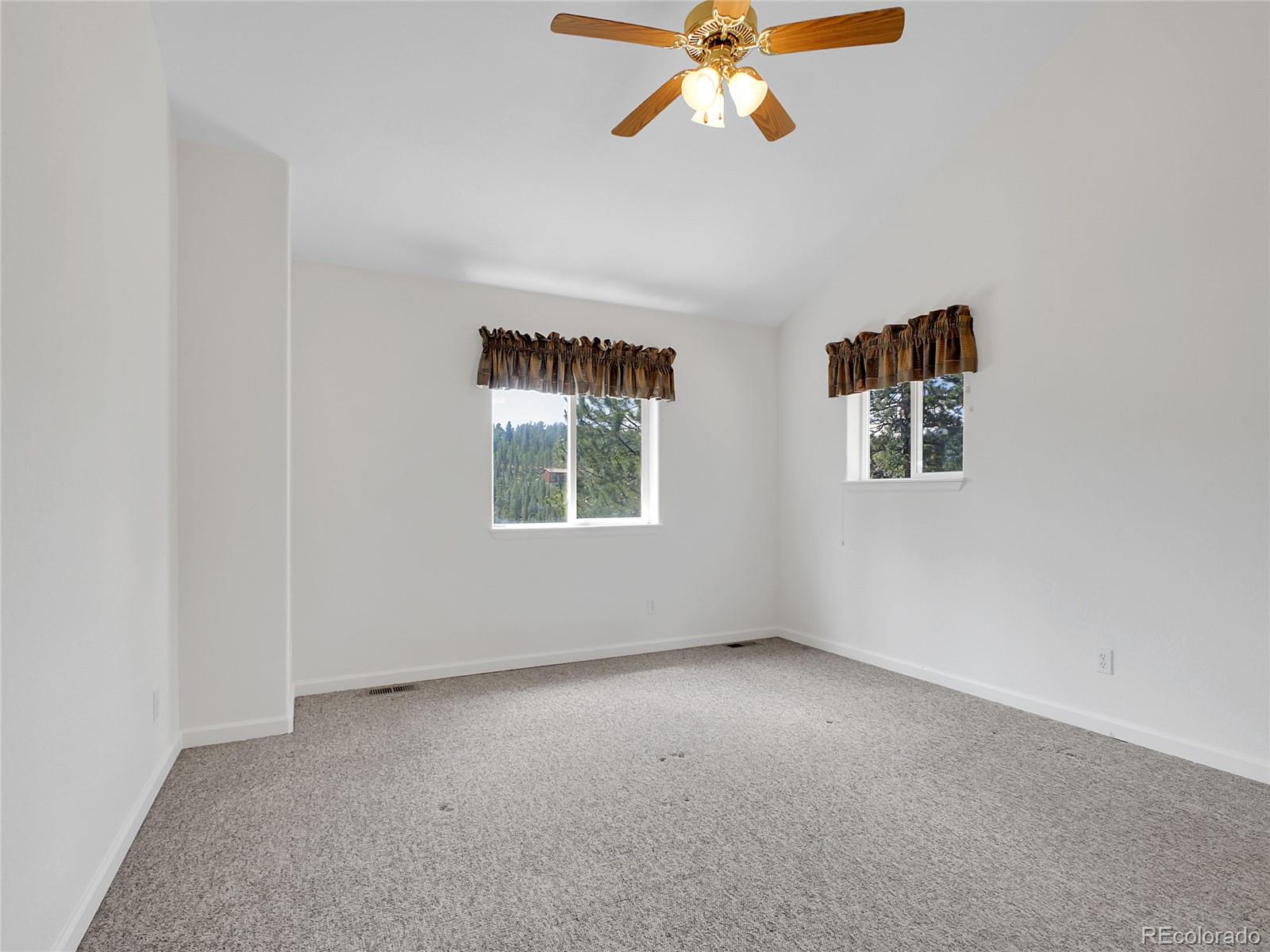 367 Moore Street Bailey, CO 80421 - Photo 16 of 32 an empty room with windows and fan