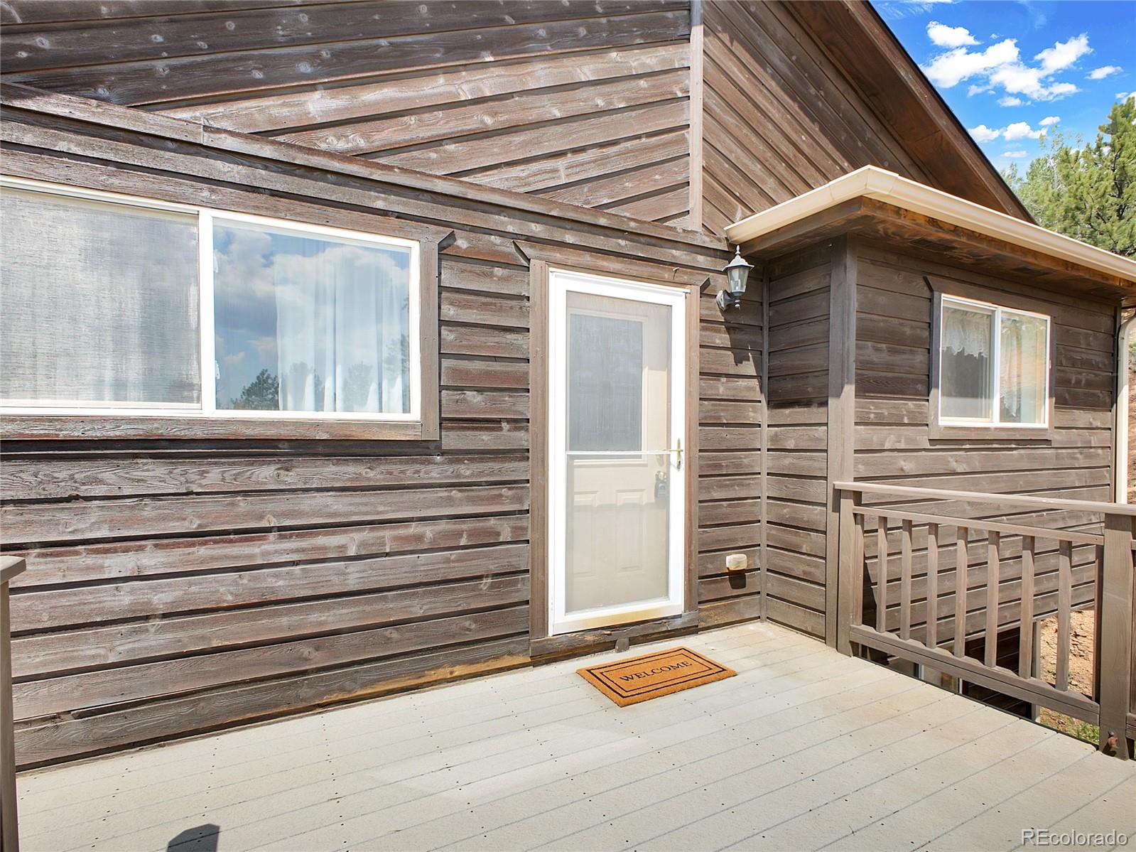 367 Moore Street Bailey, CO 80421 - Photo 5 of 32 a backyard of a house with seating space