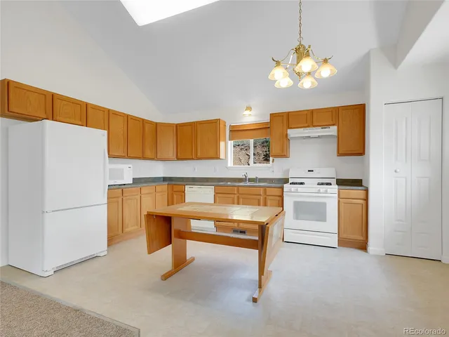 a living room with fireplace furniture and a chandelier