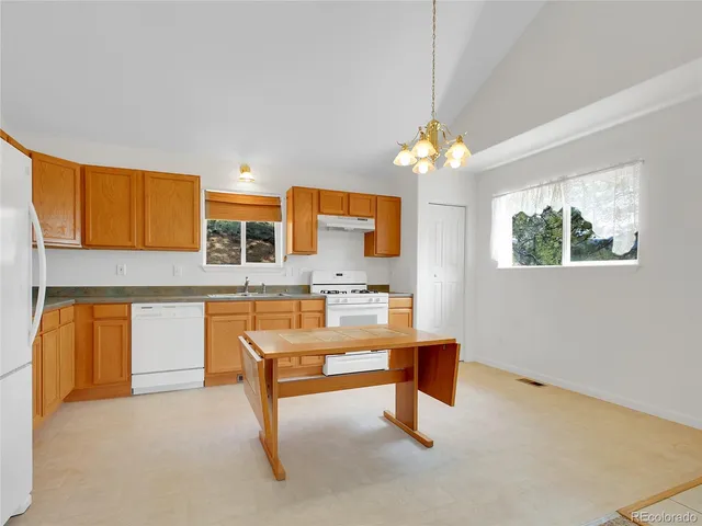 a kitchen with a stove top oven sink and cabinets