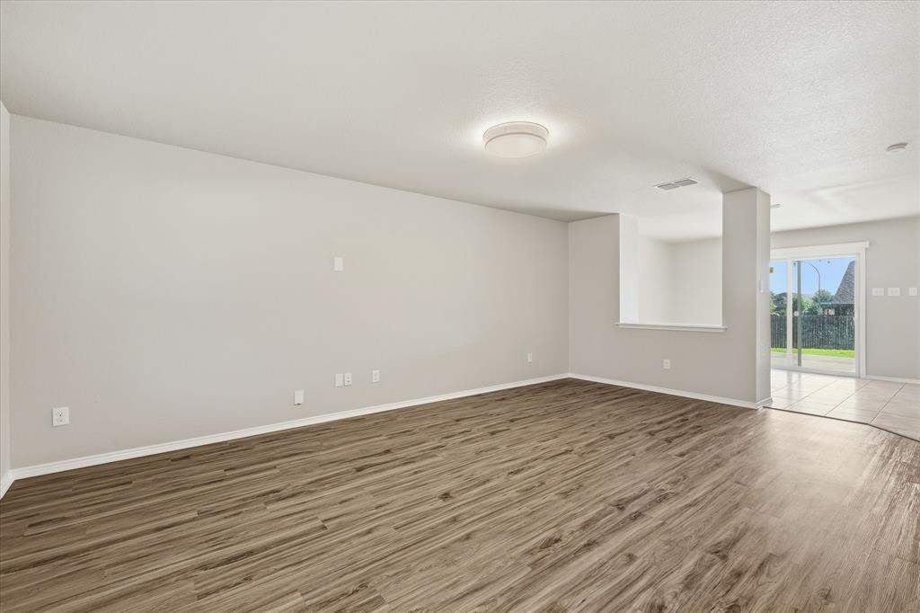 7708 Boat Wind Road Fort Worth, TX 76179 - Photo 3 of 23 Entrance with wood style floors, textured ceiling and flush mount lighting