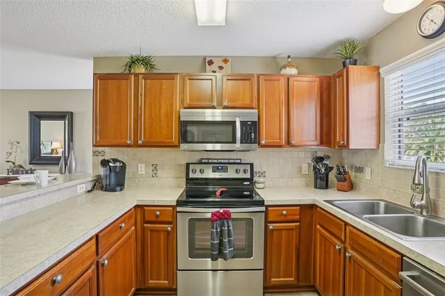 a kitchen with stainless steel appliances a stove sink and microwave