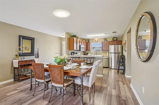 a dining room with furniture and a view of kitchen
