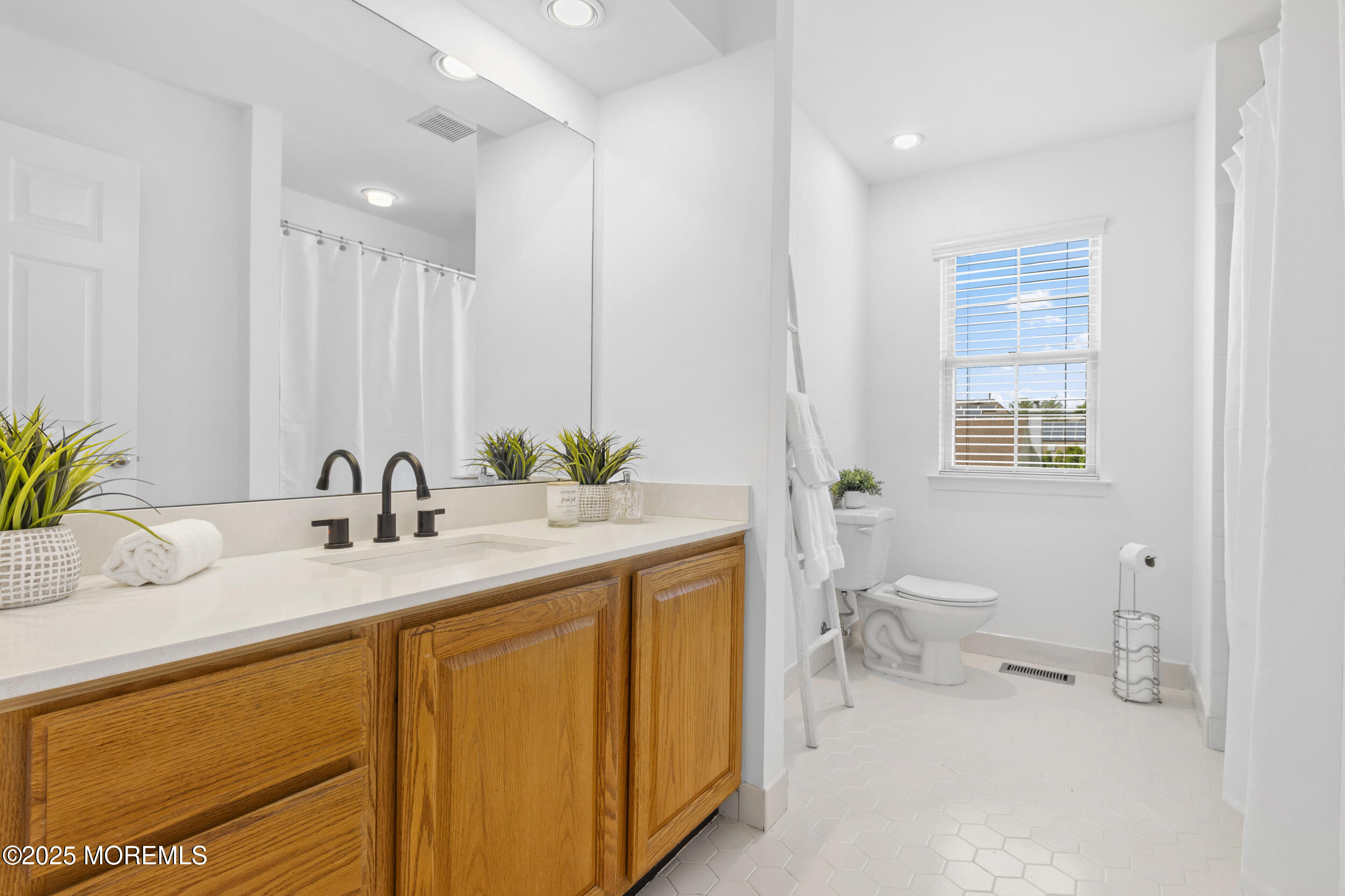 27 Danella Way Howell, NJ 07731 - Photo 19 of 25 a bathroom with a sink a toilet and mirror