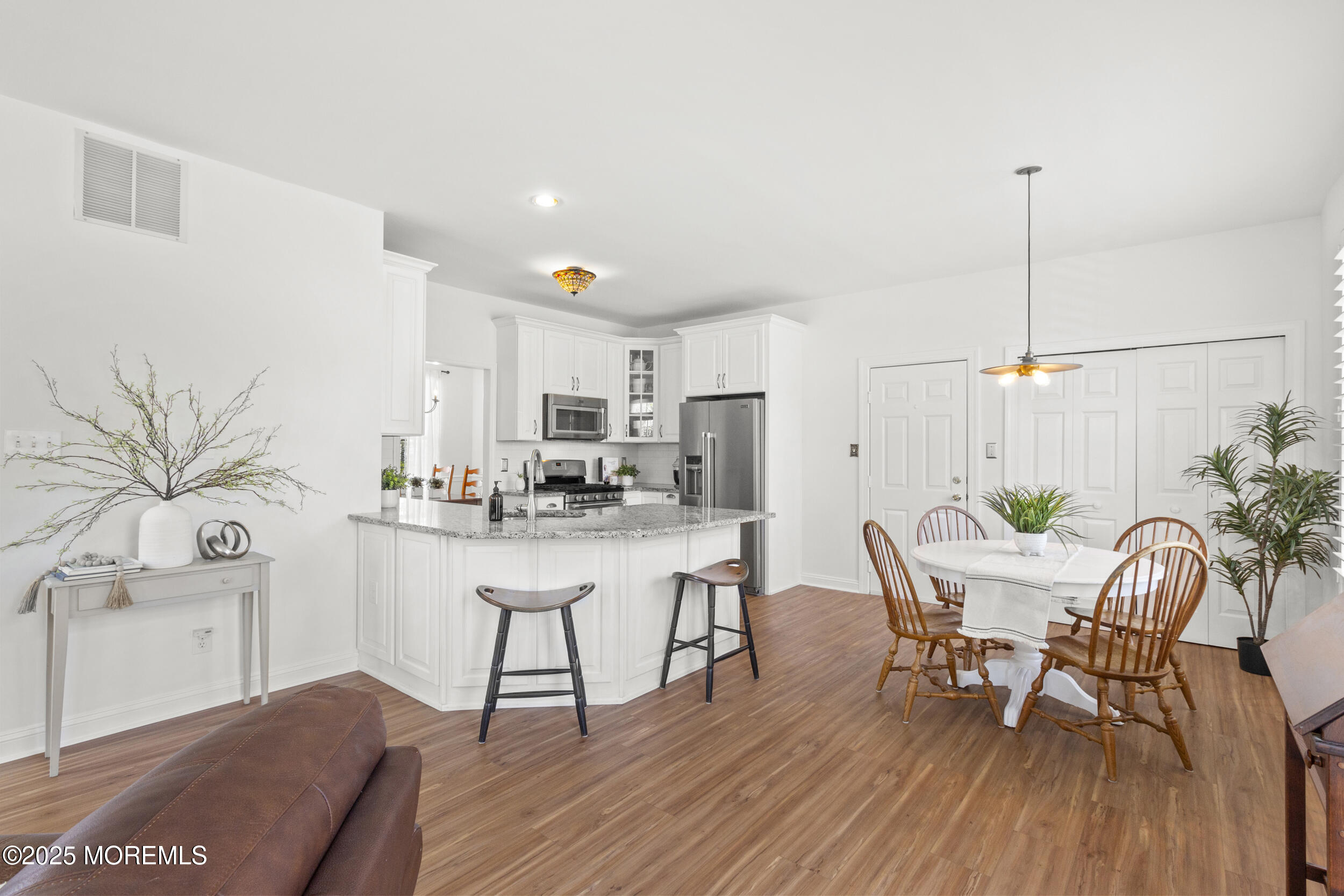 27 Danella Way Howell, NJ 07731 - Photo 3 of 25 a view of a dining room with furniture and wooden floor