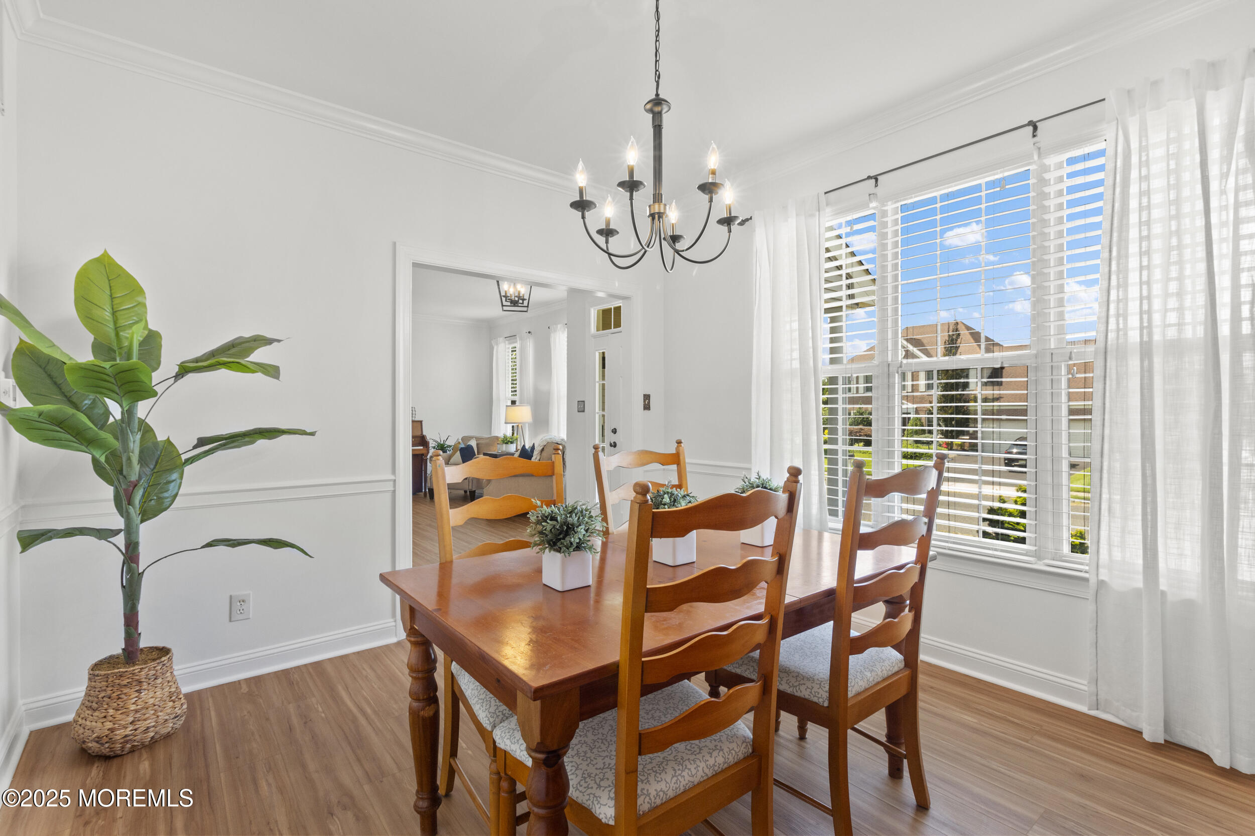 27 Danella Way Howell, NJ 07731 - Photo 8 of 25 a dining room with furniture potted plants and wooden floor