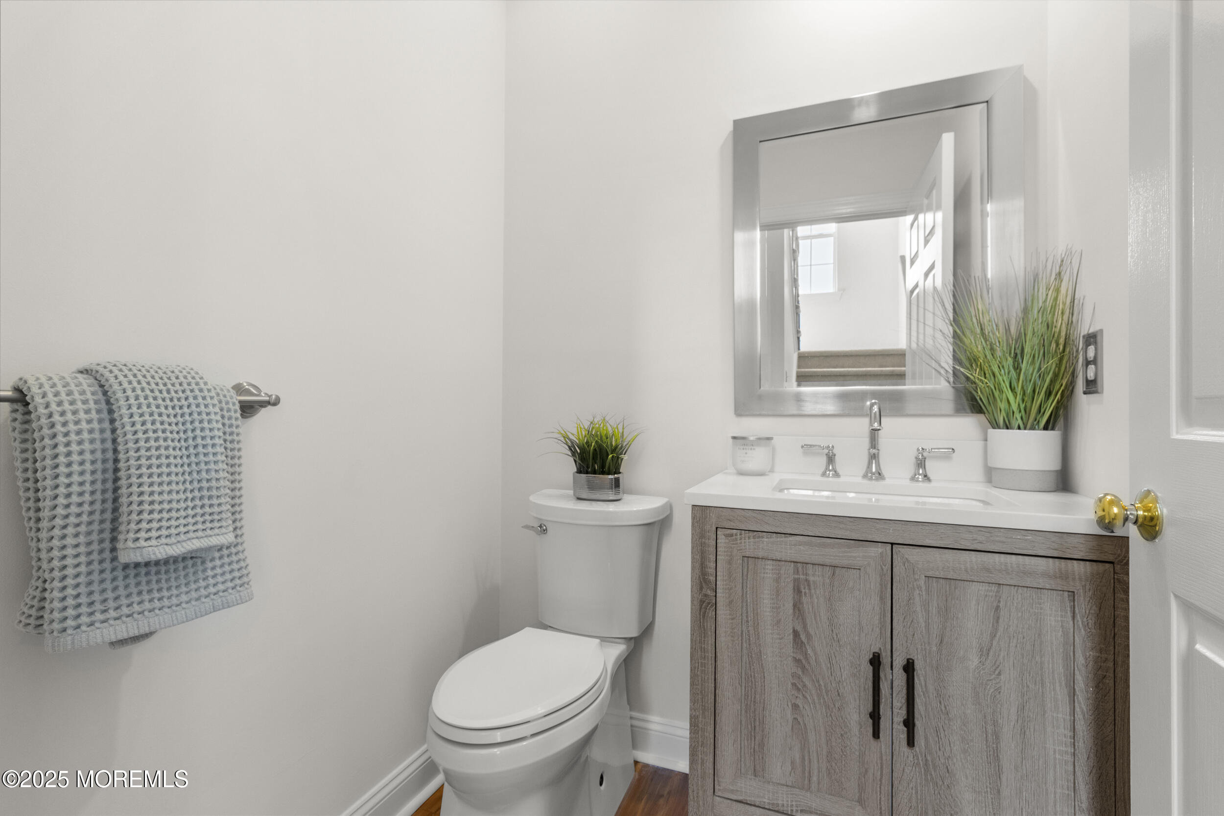 27 Danella Way Howell, NJ 07731 - Photo 10 of 25 a bathroom with a toilet a sink and mirror