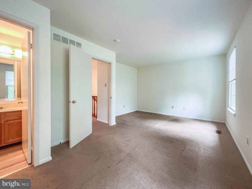 14 Carousel Circle Doylestown, PA 18901 - Photo 22 of 35 an empty room with a window and a kitchen