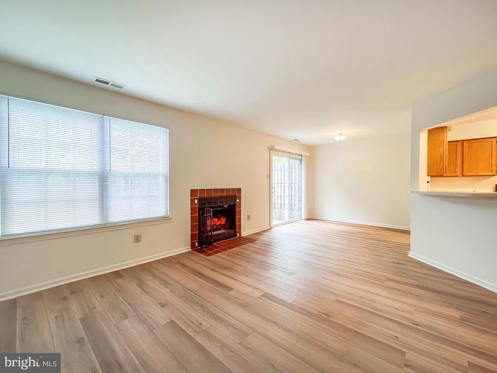 14 Carousel Circle Doylestown, PA 18901 - Photo 7 of 35 a view of an empty room with a window and wooden floor