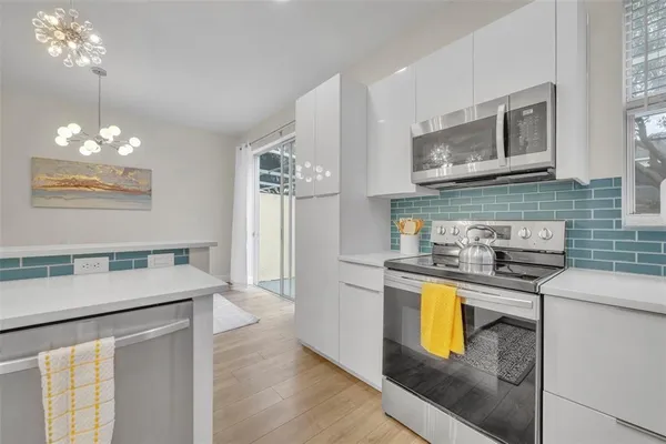 a kitchen with stainless steel appliances granite countertop a stove a sink and a refrigerator
