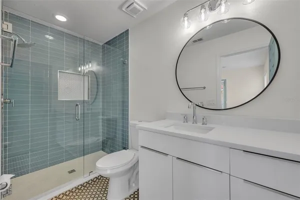 a bathroom with a sink toilet and a mirror