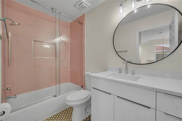 a bathroom with a sink a toilet and a mirror