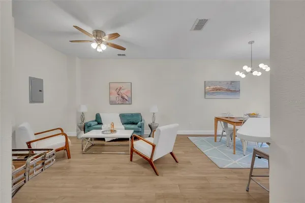 a view of a livingroom with furniture and a chandelier fan