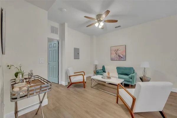 a living room with furniture and wooden floor