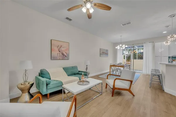 a living room with furniture and a chandelier