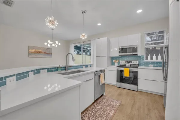 a kitchen with kitchen island granite countertop a sink counter top space stainless steel appliances and cabinets