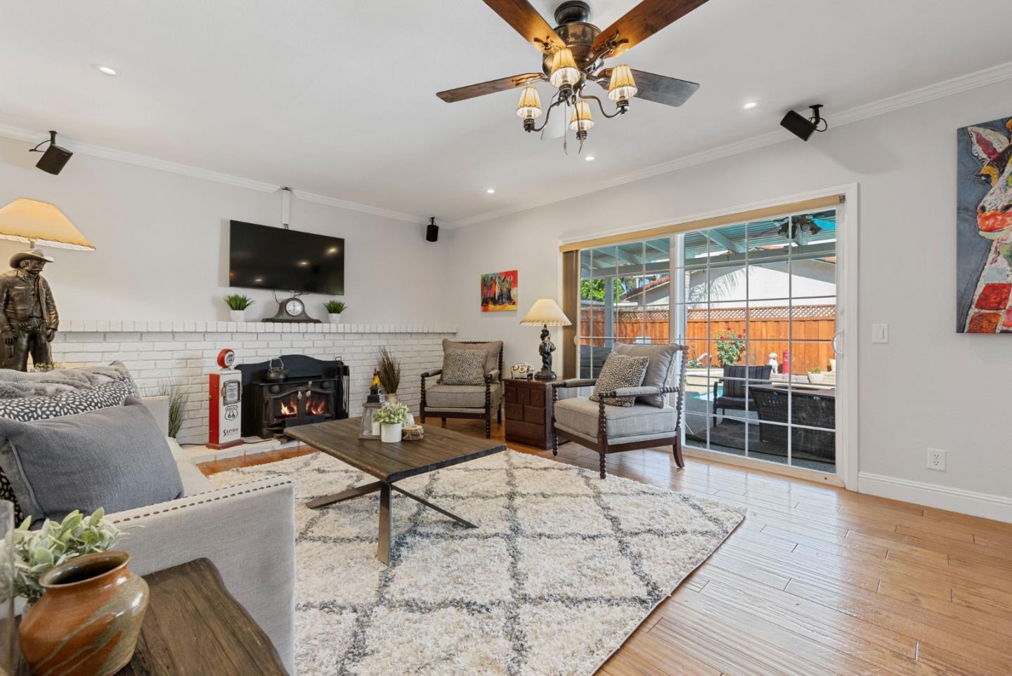 6570 Thames Drive Gilroy, CA 95020 - Photo 9 of 30 a living room with furniture a flat screen tv and a floor to ceiling window