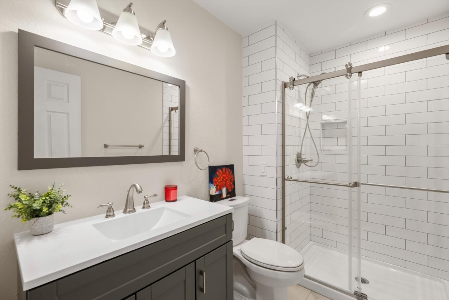 6570 Thames Drive Gilroy, CA 95020 - Photo 10 of 30 a bathroom with a sink vanity mirror and toilet