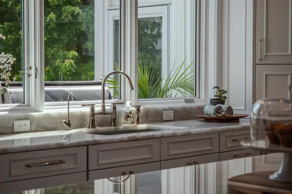 a living room with furniture and floor to ceiling windows