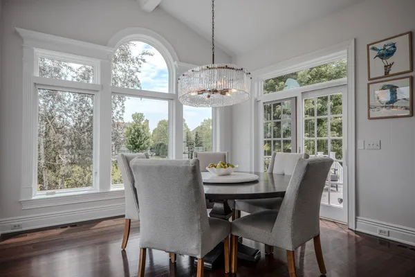 a living room with furniture chandelier and a flat screen tv
