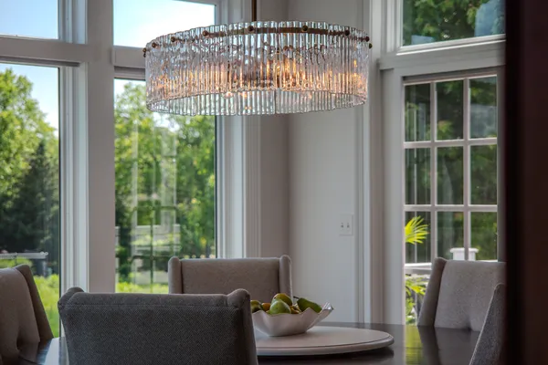 a living room with furniture a chandelier and a window