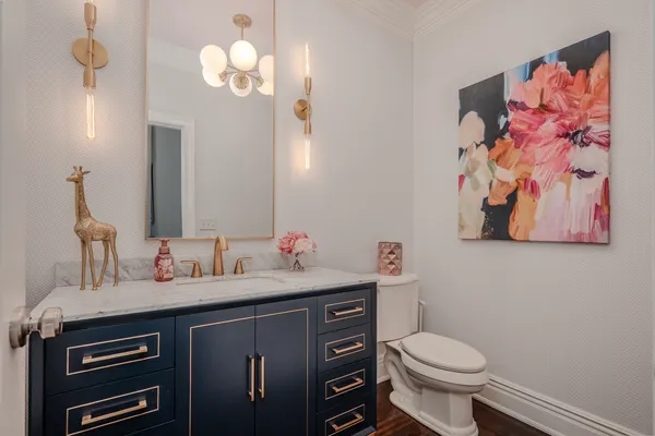 a bathroom with a granite countertop sink double vanity mirror and a bathtub
