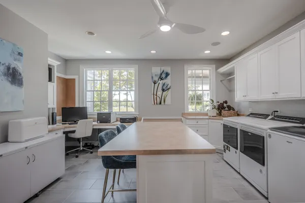 a spacious bathroom with a double vanity sink a large mirror and a bathtub