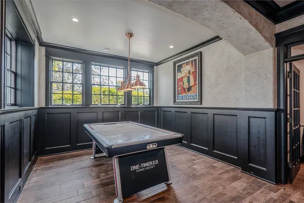 a view of a garden with plants and large trees