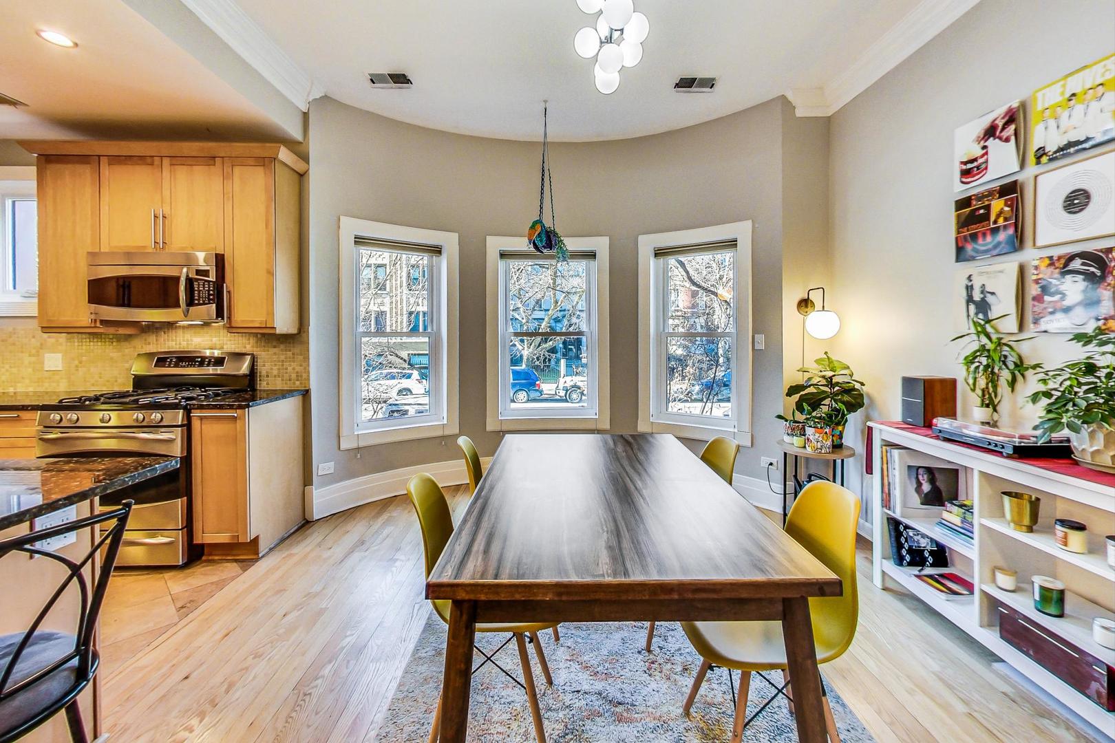 4061 North Sheridan Road, Unit 1 Chicago, IL 60613 - Photo 11 of 26 a view of a dining room with furniture window and wooden floor