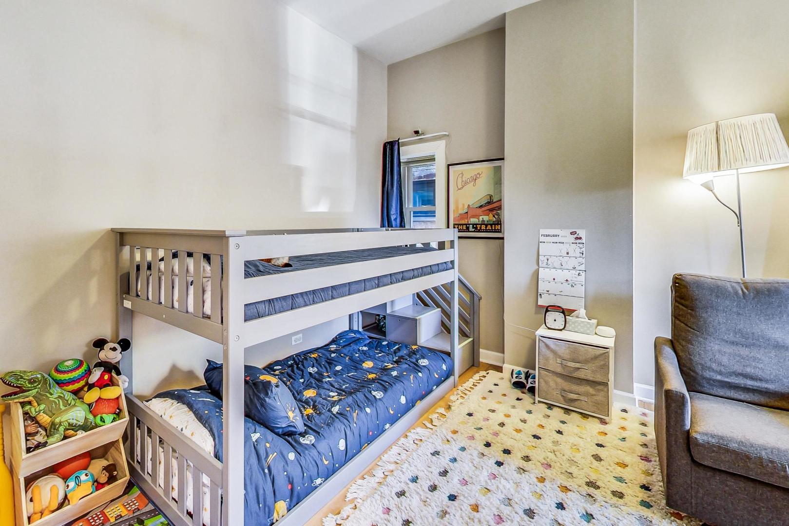 4061 North Sheridan Road, Unit 1 Chicago, IL 60613 - Photo 18 of 26 a bedroom with a bed and a couch