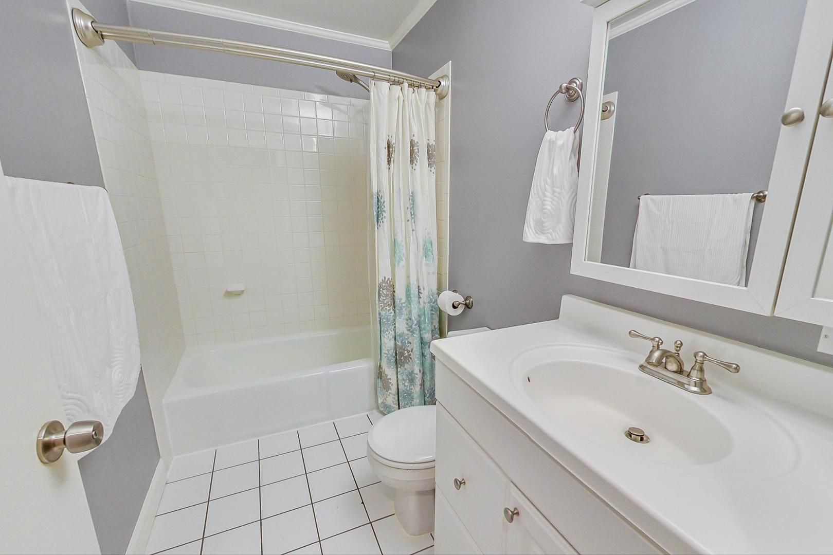 4061 North Sheridan Road, Unit 1 Chicago, IL 60613 - Photo 22 of 26 a bathroom with a sink a toilet and shower