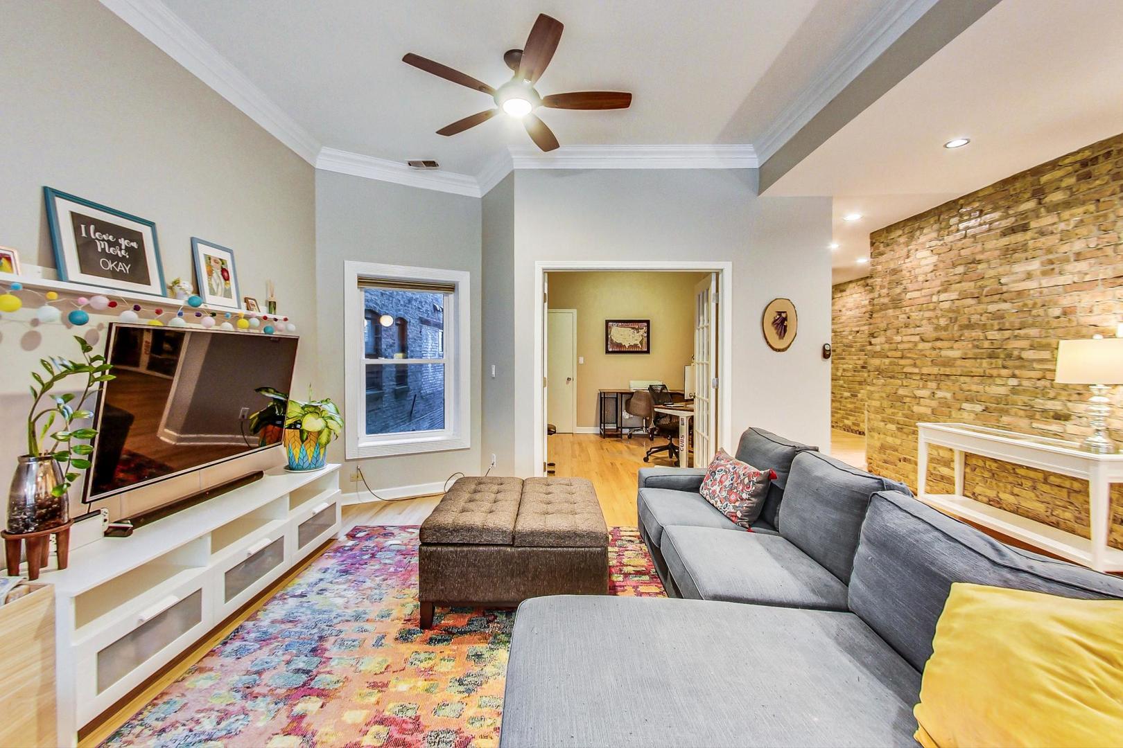 4061 North Sheridan Road, Unit 1 Chicago, IL 60613 - Photo 3 of 26 a living room with furniture and a flat screen tv