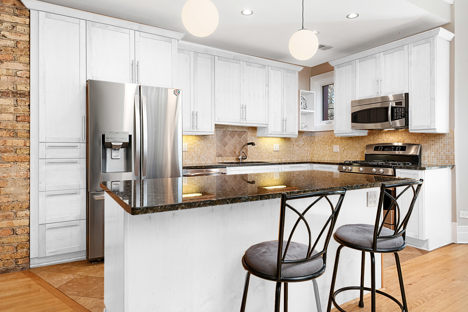 4061 North Sheridan Road, Unit 1 Chicago, IL 60613 - Photo 6 of 26 a kitchen with stainless steel appliances a refrigerator and a stove top oven