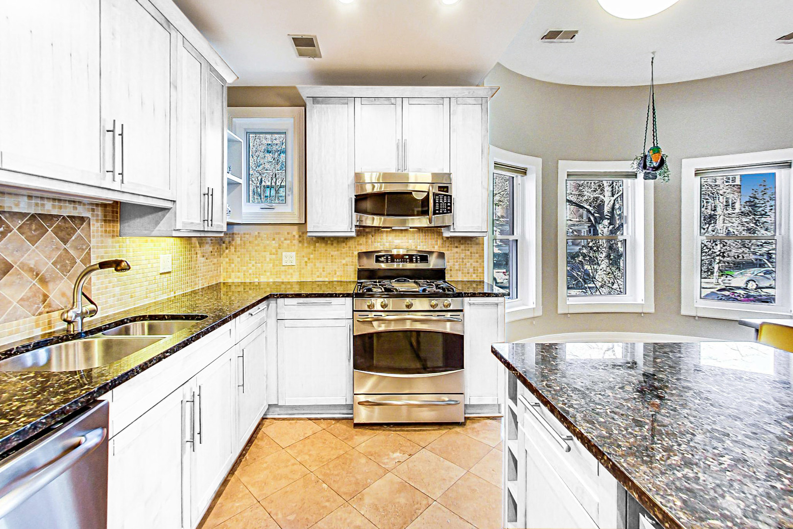 4061 North Sheridan Road, Unit 1 Chicago, IL 60613 - Photo 8 of 26 a kitchen with stainless steel appliances granite countertop a stove and a sink